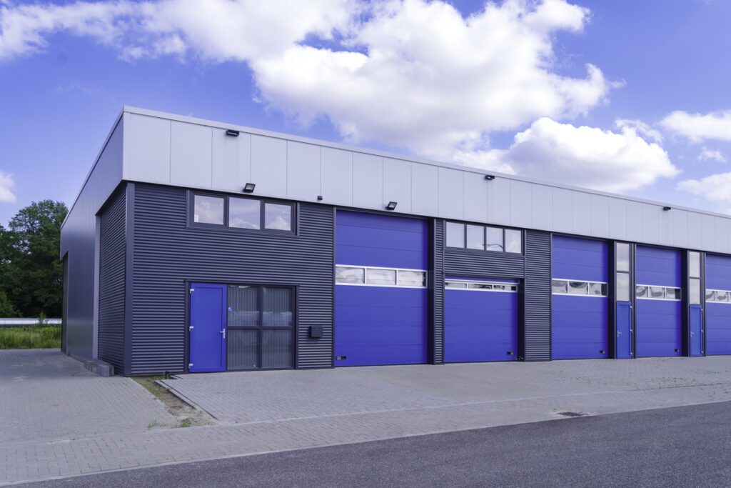 Industrial building with blue garage doors.